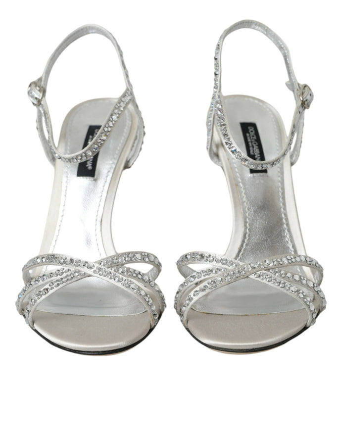 a pair of silver high heeled shoes on a white background