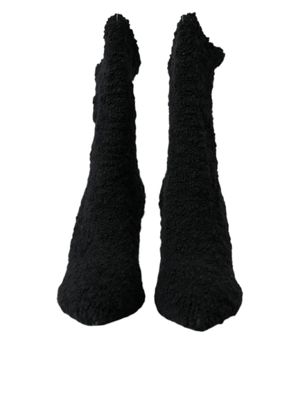 a pair of black socks that are on a white background