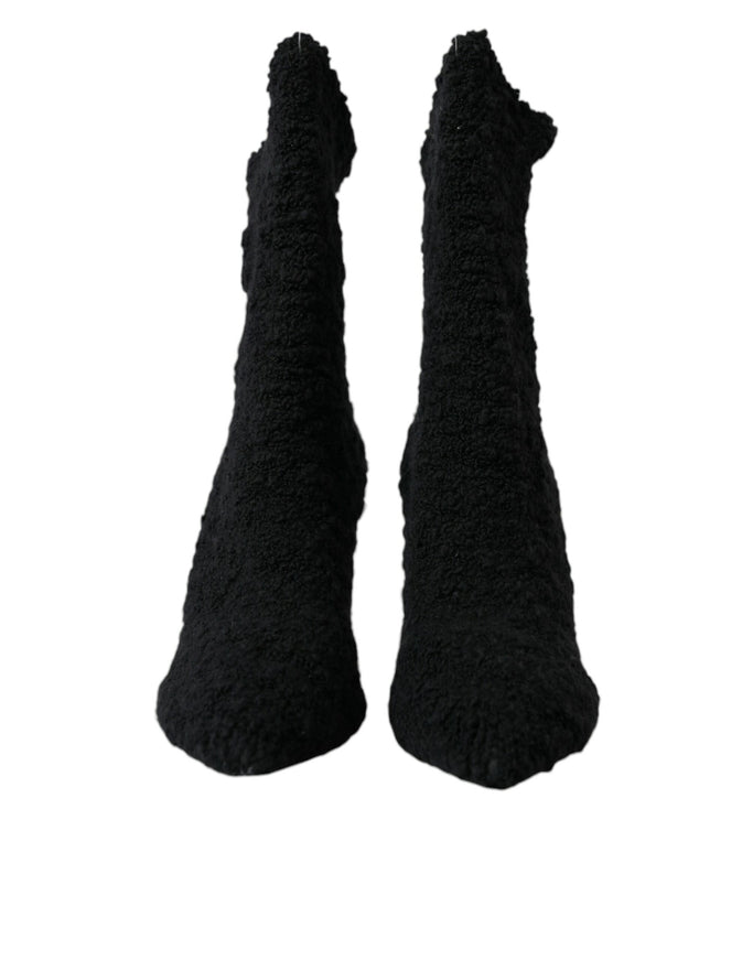 a pair of black socks that are on a white background