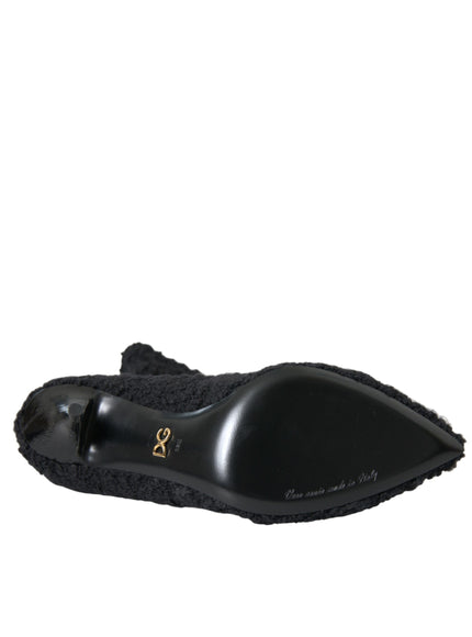 a pair of black slippers on a white background