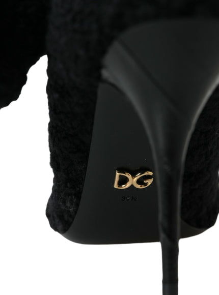 a black high heeled shoe with a gold logo