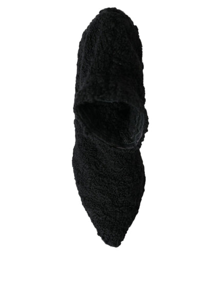 a pair of black slippers on a white background