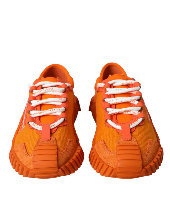 a pair of orange sneakers with white laces