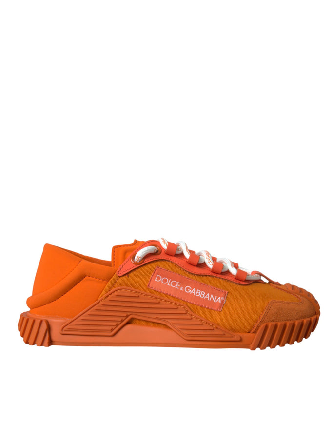 a pair of orange sneakers with a white sole