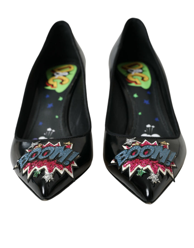 a pair of black high heels with a cartoon character on the heel