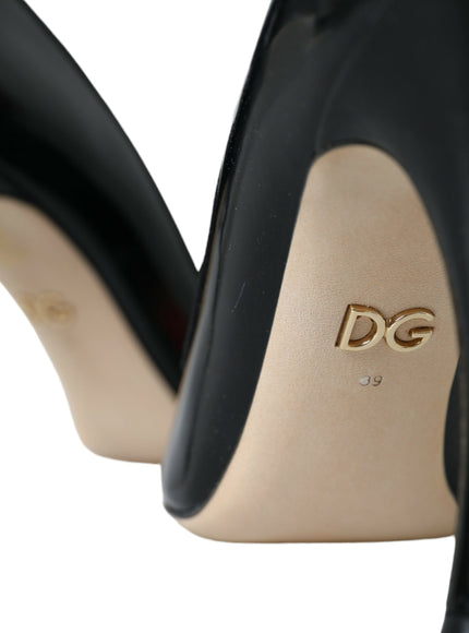 a pair of black high heels with a gold dg logo