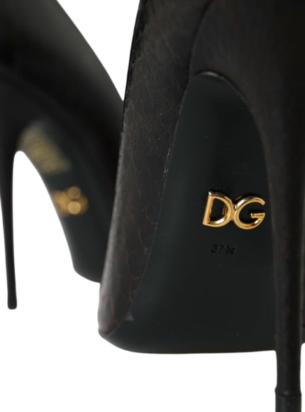 a pair of black high heels with a gold logo