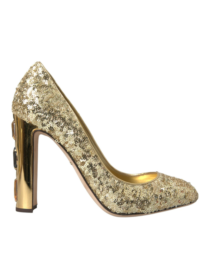 a gold high heeled shoe with a metal heel