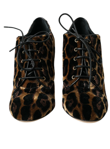 a pair of leopard print shoes on a white background