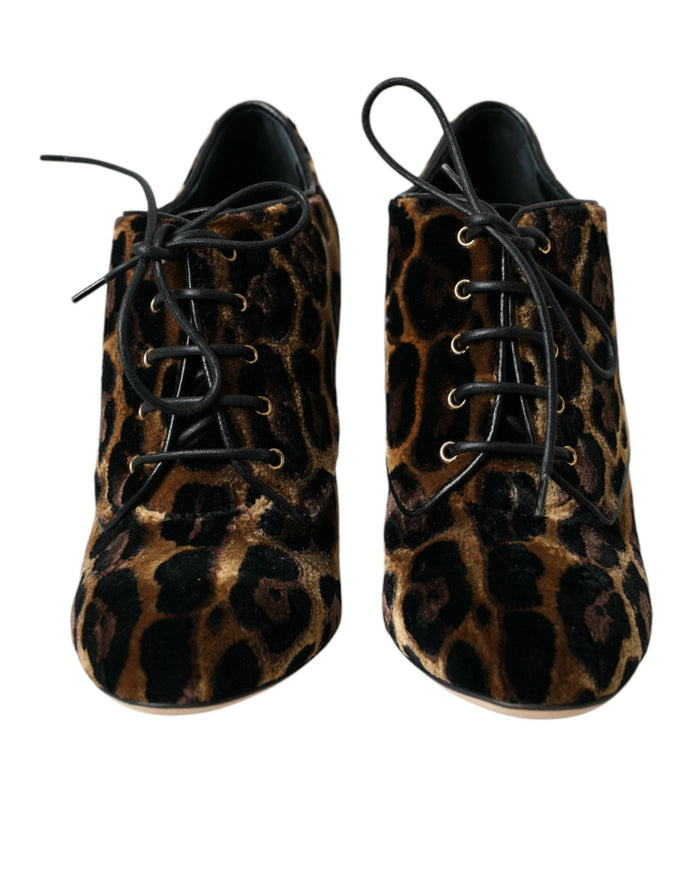 a pair of leopard print shoes on a white background