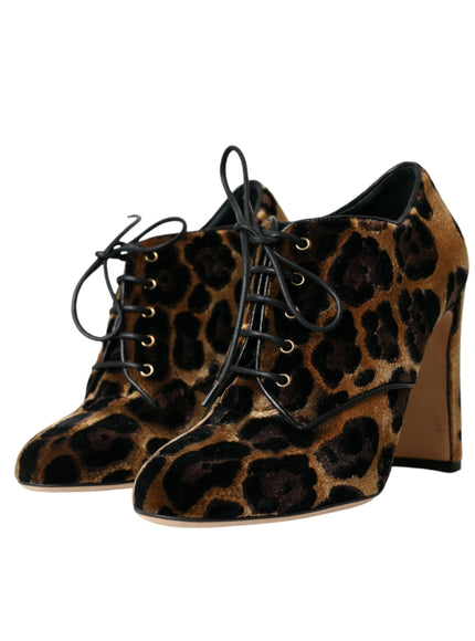 a pair of leopard print shoes on a white background