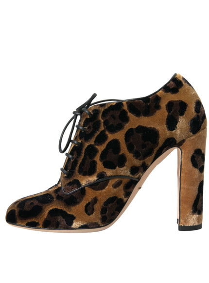 a pair of leopard print shoes on a white background