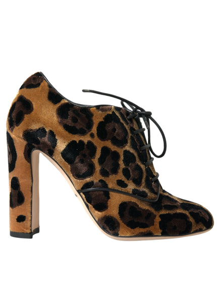 a pair of leopard print shoes on a white background