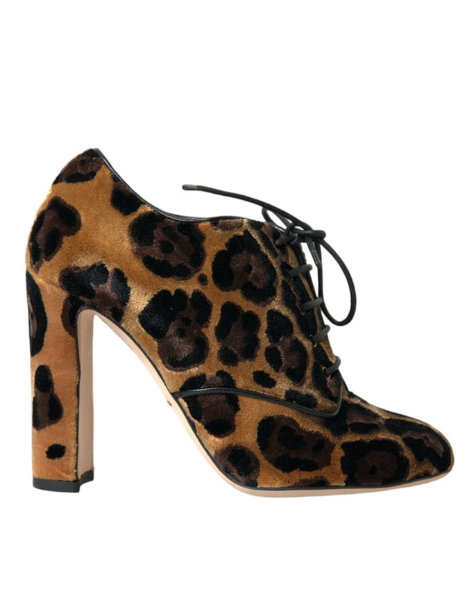 a pair of leopard print shoes on a white background