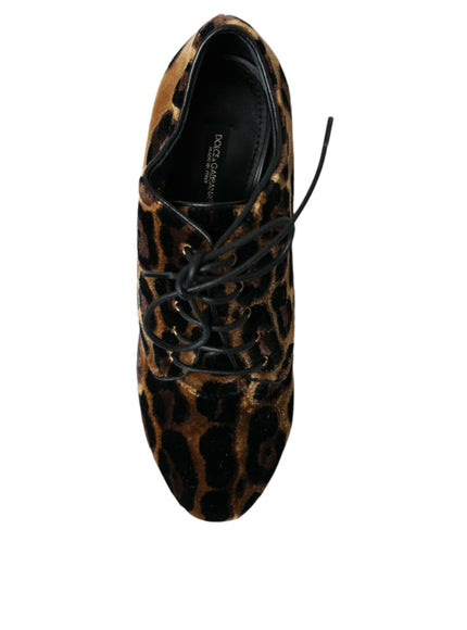 a pair of leopard print shoes on a white background