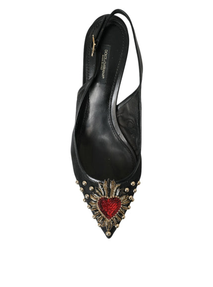 a pair of black high heels with a red heart on the heel