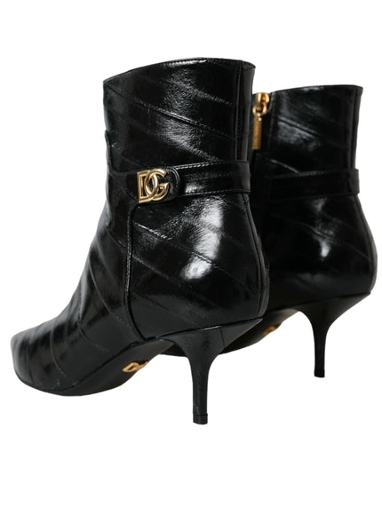 a pair of black boots with a gold buckle