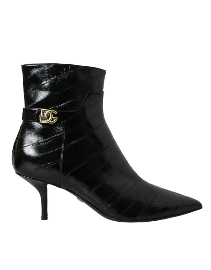 a pair of black boots with a gold buckle