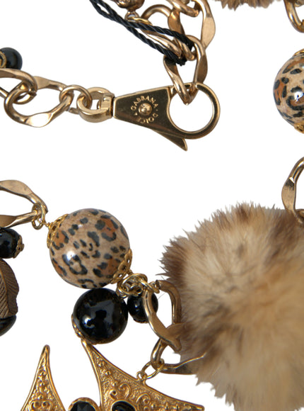 a close up of a key chain with a fur ball on it