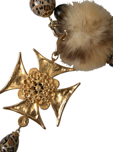 a pair of earrings with a fur ball on top of it