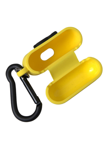 a yellow object with a black hook on a white background