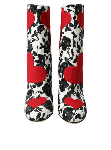 a pair of black and white boots with red hearts