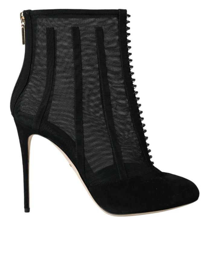 a pair of black high heeled shoes with zippers