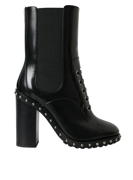 a pair of black boots with spikes on the heel