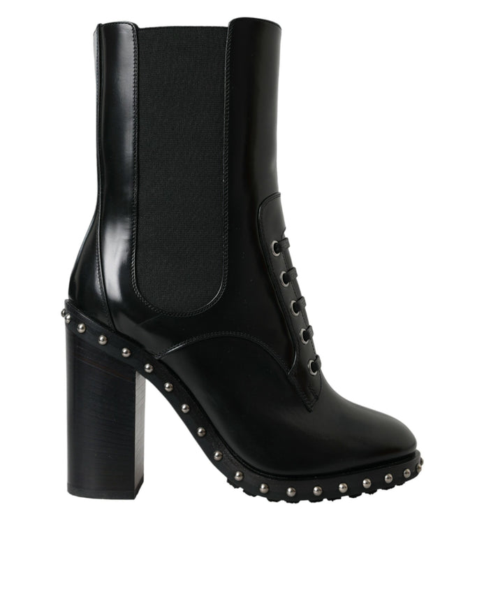 a pair of black boots with spikes on the heel