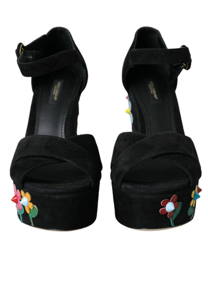 a pair of black high heels with flowers on them