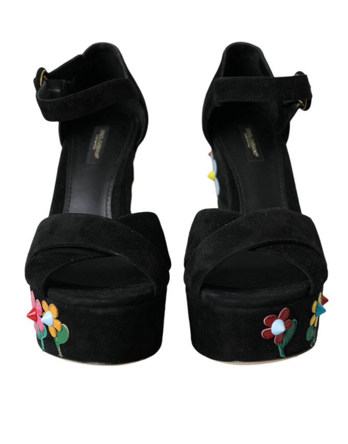 a pair of black high heels with flowers on them