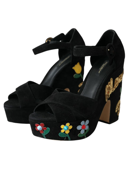 a pair of black high heels with flowers on them