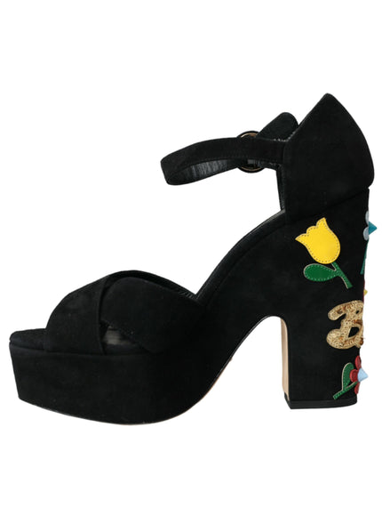 a black high heeled shoe with a yellow rose on it