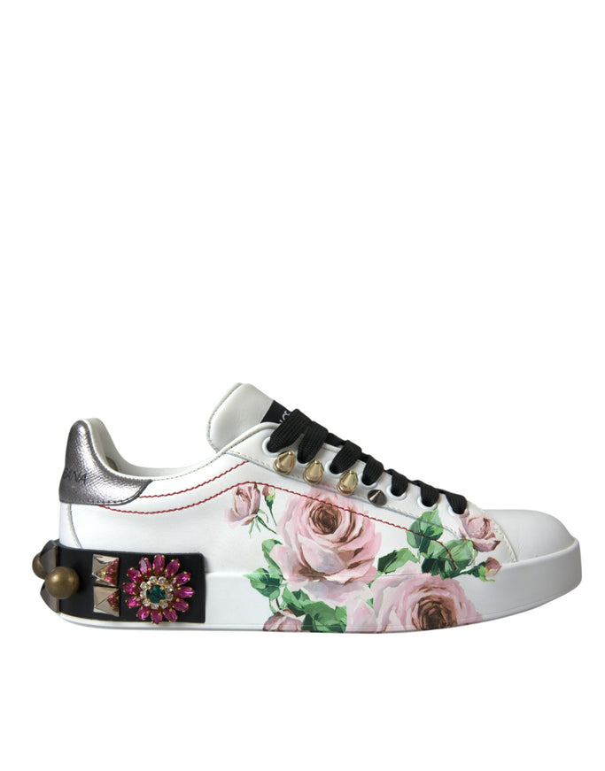 a pair of white sneakers with pink roses on them