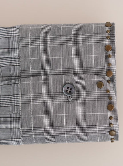 a close up of a shirt with buttons on it