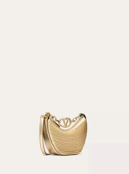 a gold purse with a chain hanging from it