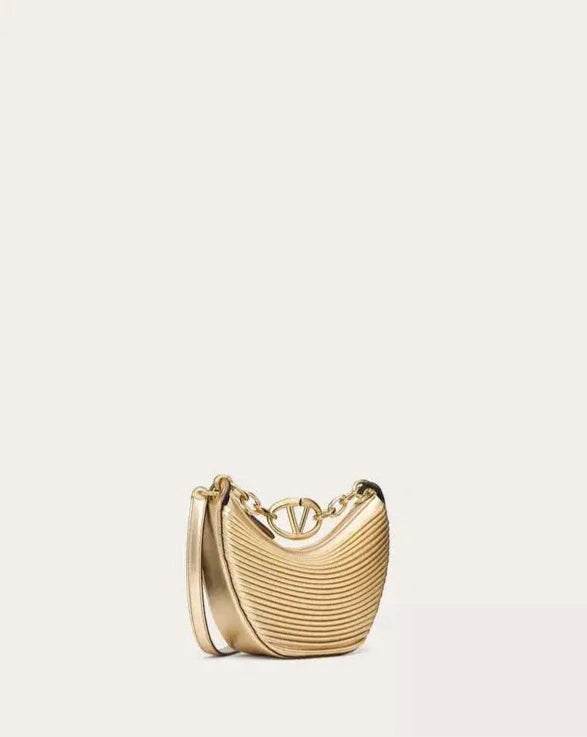 a gold purse with a chain hanging from it