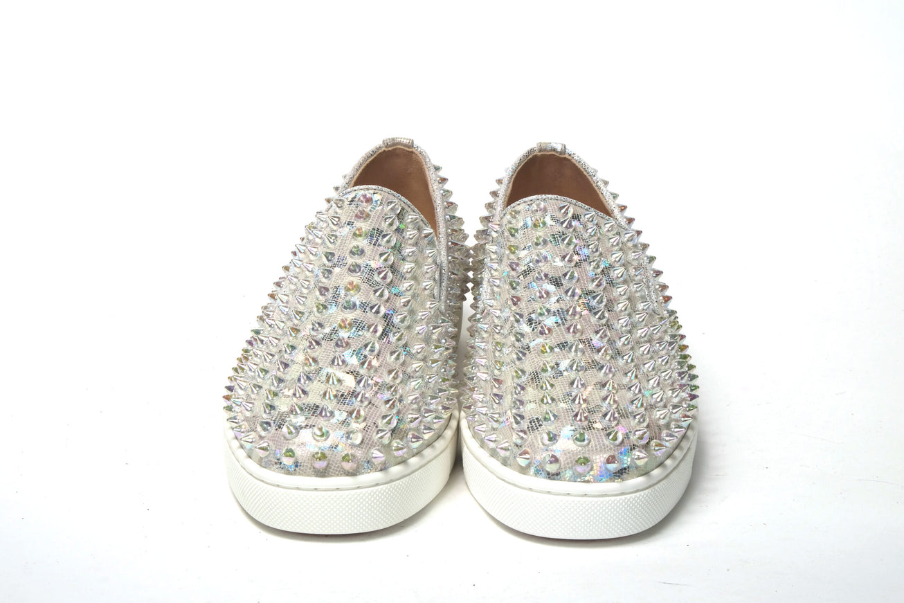 a pair of white shoes with silver sequins on them