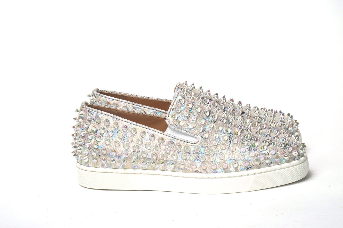 a pair of white shoes with silver sequins