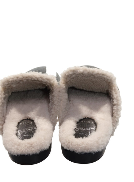 a pair of black and white slippers on a white background