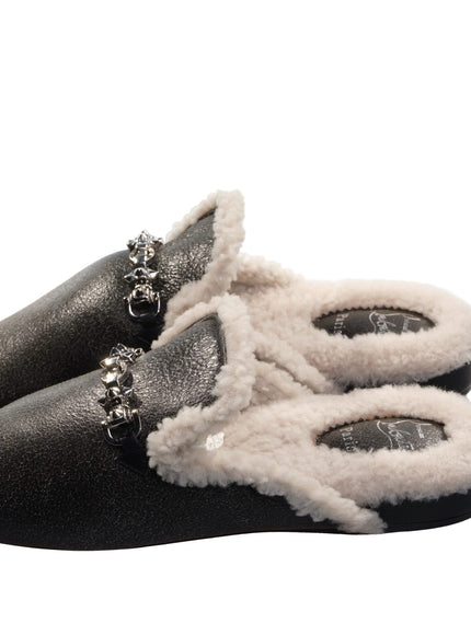 a pair of black and white slippers on a white background