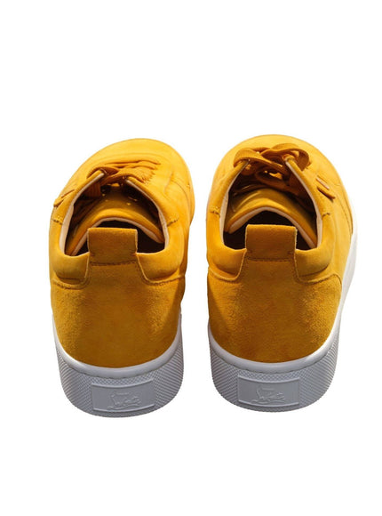 a pair of yellow sneakers on a white background