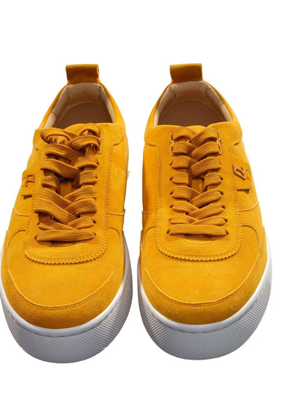 a pair of yellow sneakers with white soles