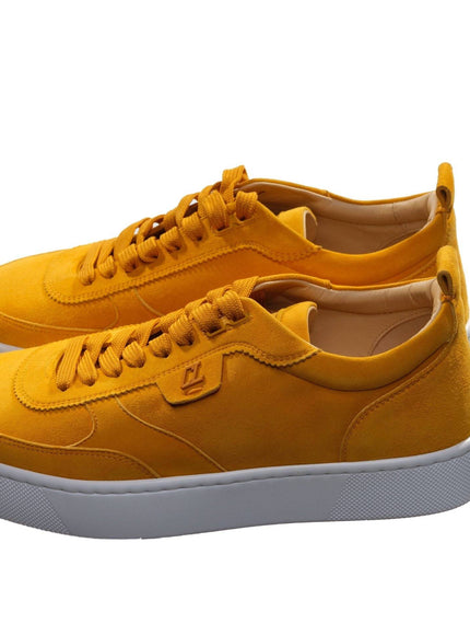 a pair of yellow sneakers on a white background