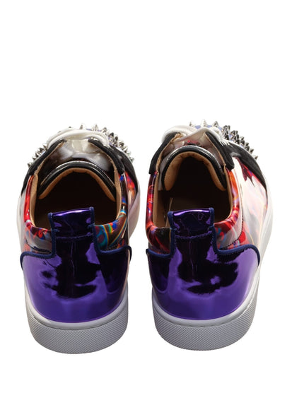 a pair of purple and red shoes with spikes on them