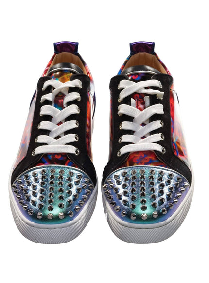 a pair of black and white sneakers with multicolored spikes