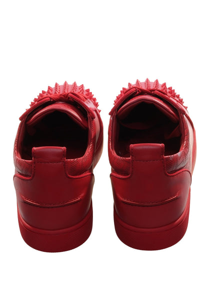 a pair of red shoes with spikes on them