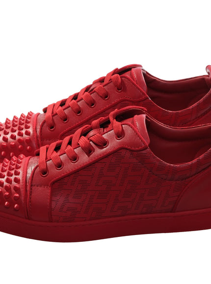 a pair of red shoes with spikes on them