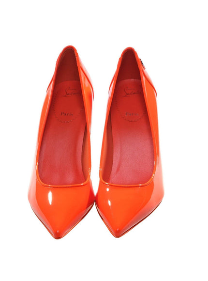 a pair of orange high heels on a white background