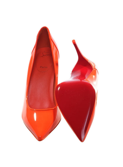 a pair of red high heeled shoes with a pointed toe